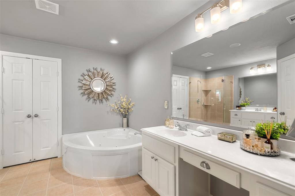 The master bath features dual vanities, jetted tub and professionally cleaned and sealed floor tile.