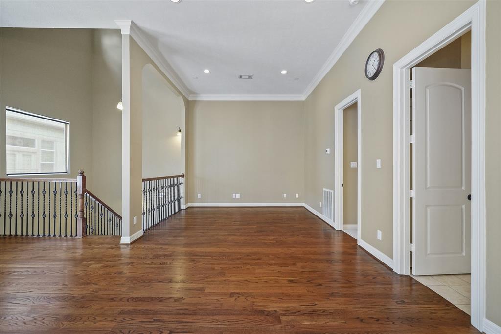 The main living space also includes recessed lighting, high ceilings, and crown molding.
