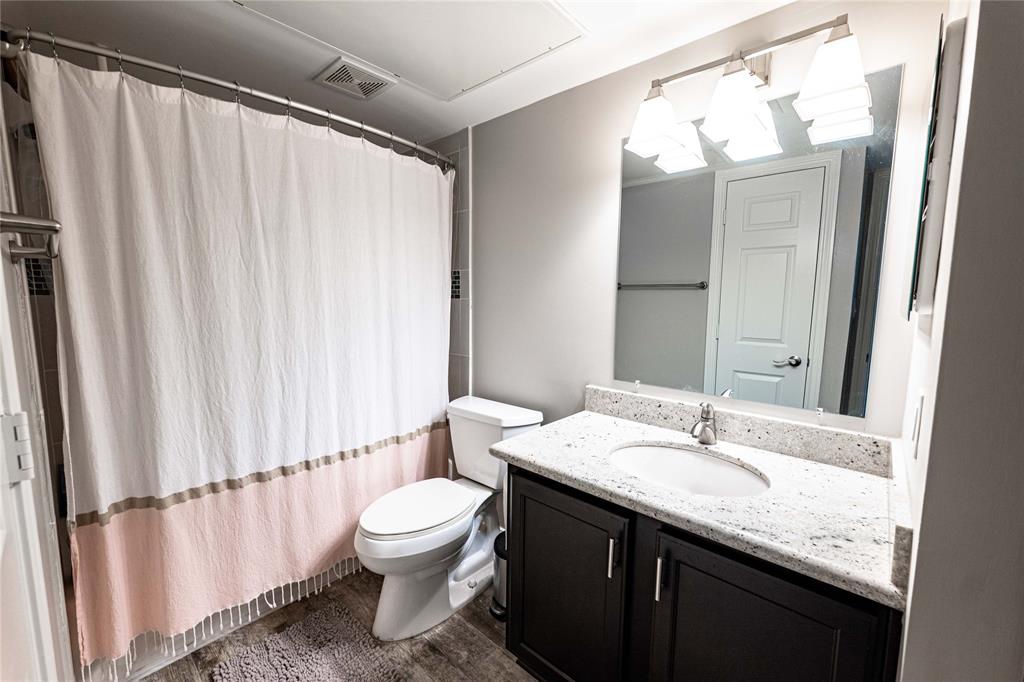 The bathroom is fresh with updated cabinets and fixtures.