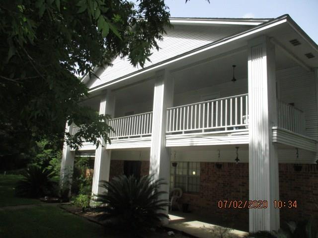 Beautiful Pecan tree lined entry! Spacious 5 bedroom with several living areas situated on 20 wooded acres! Property is fenced, and has a 2 car detached garage along with a storage building.