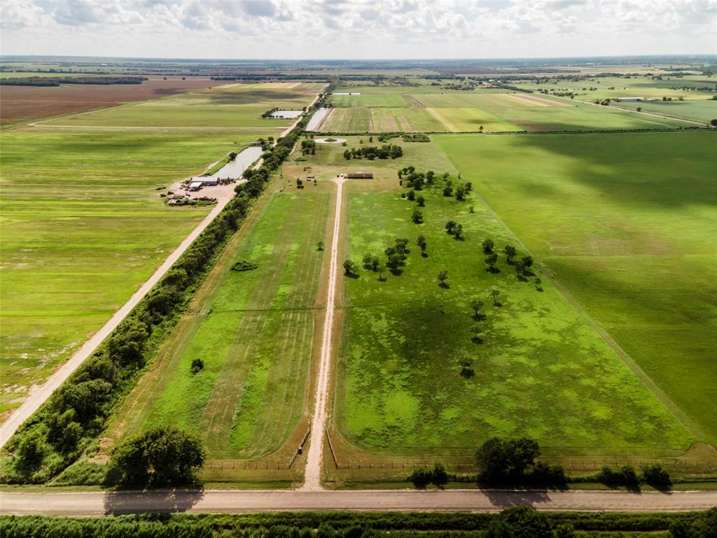 5338 County Road 166 Bay City, Texas Beautiful 30.44+/- ACRES in a private setting, just minutes from town! Plenty of room to do what you've been dreaming of plus a POND in back! The mobile home is like no other around-offers an open concept kitchen/dining/living room w/sheetrock walls, built-ins, crown moldings & coffered ceilings. Kitchen features black appliances (fridge included),big breakfast bar, & pantry. Utility room right off the kitchen. Master has a walk-in closet & attached bathroom with double sinks, soaking tub & separate shower. Stained deck on the back is ready for entertaining or just enjoying the serene setting! Room dimensions are approximate.