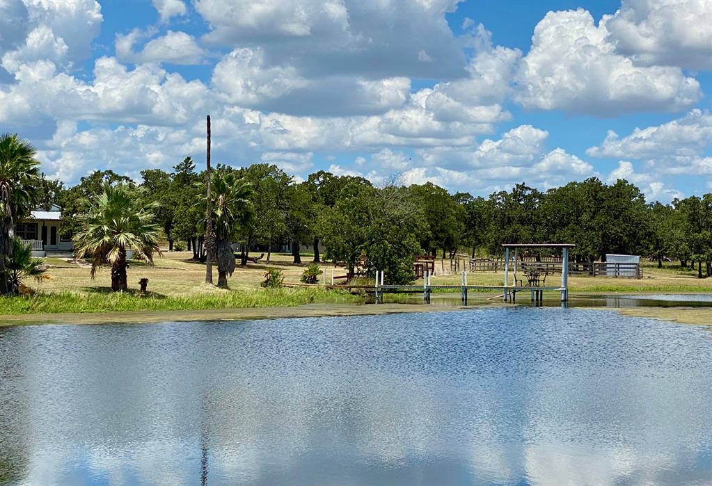 1005 Oak Drive Somerville, Texas Hard to find Texas country home on approximately 7.2 acres with views and character that makes a desired homestead or great escape destination with family and friends. This 1200 square foot home has a superb wrap around porch that embraces the sites and sounds of the country. It's pier and beam construction lends itself to easy expansion if one desires. The property's dominant feature is a beautiful, fully stocked, approximate 1.3-acre personal lake with pier and entertainment spaces. For the Tim Taylor in all of us, one will delight in the 1200 square foot enclosed shop, with over 2,400 feet of covered vehicle, work or equipment area! This little ponderosa also has a 340 square foot cabin, an additional 990 sqft barn and an RV hook up site to expand your capacity to host visiting family and friends. You will find all this just an hour's drive from the traffic lights of Houston and a little under 30 minutes to the action and entertainment of SEC country in College Station.