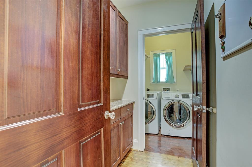 Not to be taken for granted in a classic bungalow, there is a laundry ROOM in the house, including lots of cabinets and a folding counter.  Start the laundry and close one or both doors for quiet.