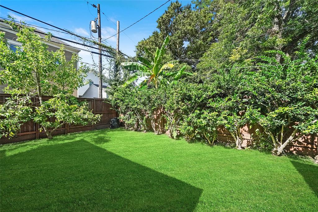 Lushly landscaped backyard matches the well-cared for appearance of the house.