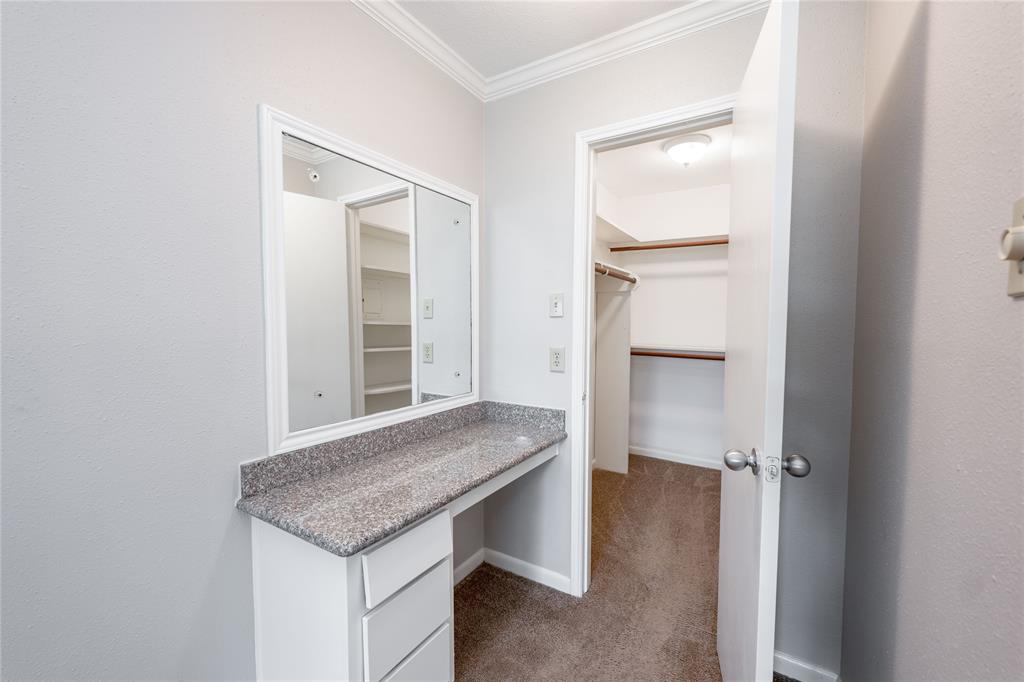 Alongside the vanity, there is a large walk-in closet.