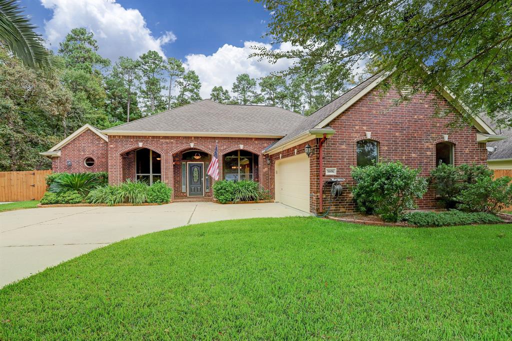 5606 Sugar Bush Drive Magnolia, Texas Beautiful one-story home situated on stunning 1/2-acre lot is surrounded by trees, lush landscape and wildlife. Backyard boasts outdoor living with a spa and large covered patio perfect for entertaining guests. Spacious gourmet kitchen equipped with 5-burner gas cooktop, walk-in pantry & large island opens to the family room. Striking floor-to-ceiling, wood-plank clad fireplace is centerpiece of light and bright home with open floorplan. High ceilings with double-tray design add character to fabulous home with crown molding throughout. Pristine hardwood floors showcase the study and sizable owner's retreat providing dual vanities, walk-in shower, whirlpool tub & spacious closet. This remarkable home is sure to leave a striking impression in a community with a rural feel, yet minutes from suburban amenities! Exemplary Magnolia ISD! LOW TAX RATE! Bonus: Hwy 249 now intersects with 1488 for quick access to Tomball and Houston metro areas!