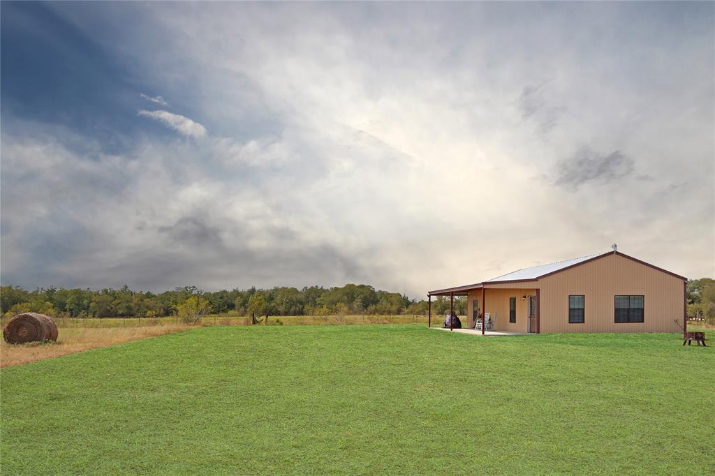 1162 County Road 123 Ledbetter, Texas This 2018 Barndominium sits on over 10 acres. Beautiful stained concrete floors flow through the entire home, as the tall ceilings and natural light from the numerous windows make the space feel big and bright. If you are looking for privacy, this property is it! Secluded from neighbors and protected by trees, the house is tucked away on top of the hill, from the hustle and bustle of town. You don't want to miss the amazing Texas sunsets on the porch, so grab a rocking chair and come check them out!