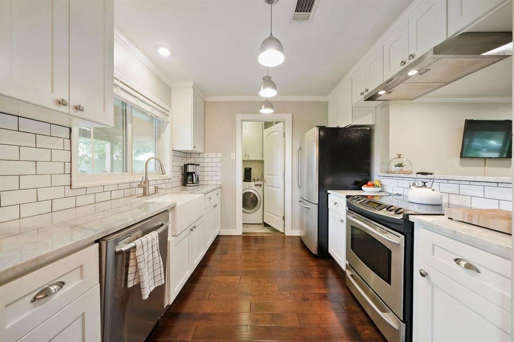This updated kitchen has beautiful subway tile, granite counter tops, and stainless steel appliances.