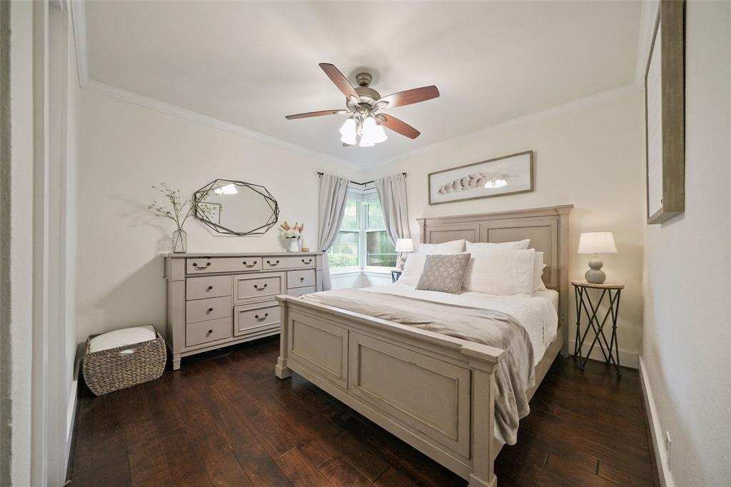 This primary bedroom features beautiful trim and wood floors.