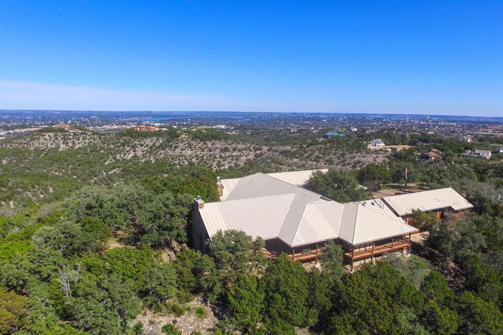 17301 Flint Rock Road Austin, Texas Extraordinary 28 acre, gated estate in the heart of Lakeway. Incredible views from one of the highest hills in the area. Total privacy from this nearly 11,000 sq ft Colorado style Mountain Lodge, 2500 sqft of outdoor living areas. 2/2 guest cottage. Not in city limits, no restrictions! This would make an incredible venue or development opportunity. Rough Hollow marina minutes away. Frontage on Flint Rock Rd. Lake Travis ISD! Additional acreage also available.