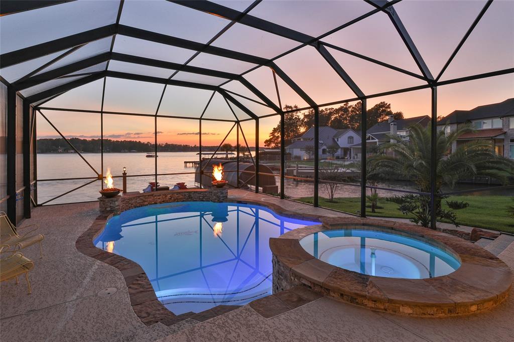 64 Lake Bluff Montgomery, Texas Welcome home to Prestigious Lake living in Bentwater on Lake Conroe! When you enter the Bentwater community you will be greeted by the friendly staff at the manned gate. Not only is this gorgeous home in the golf course community but it is also waterfront living with your own private covered boat slip w/boat lift & two jet ski lifts which has all been recently redone and updated. The beautiful pool w/waterfall & firepit features & hot tub are screened in. Enjoy your entire day on the large covered back patio. Inside is just as gorgeous as outside plus you have all the lake views while inside. This open concept home has a beautiful kitchen w/granite countertops, stainless steel appliances that opens to the dining & living room areas. The primary bedroom & bathroom as well as another bedroom & full bathroom are downstairs plus a nice study w/french doors w/gorgeous built-ins. Upstairs features a gameroom, huge media room, bedroom & full bathroom and an extra room for whatever you desire.