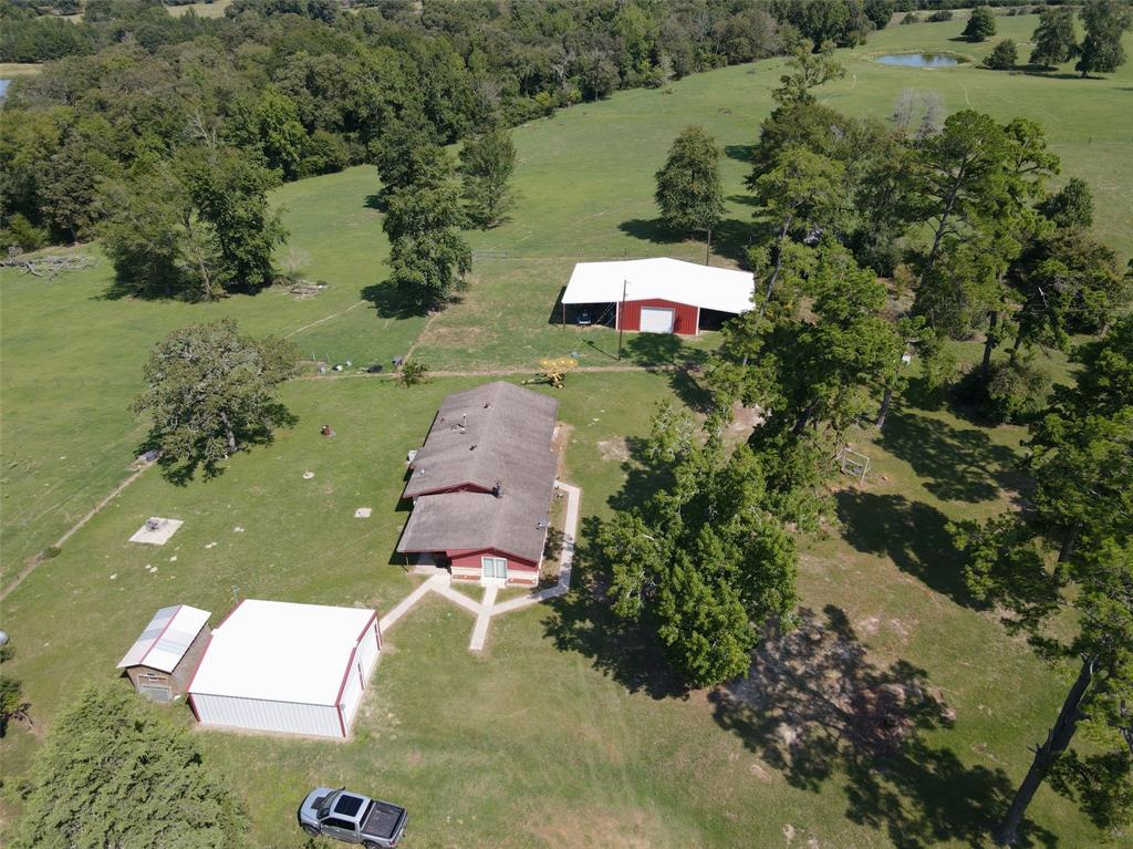 4395 CR 282 Buffalo, Texas 40.86 acres fronts on CR 282. As you enter the property, the gorgeous green pasture and panoramic views help you realize the great beauty of the Flo, Texas terrain. There is a 3 bedroom, 1 bath brick home on the property, and it comes with all the major appliances. There is also a hot tub included, perfect for relaxing. There is a detached metal garage and a 1200 sq. ft. Red Dot building that are great assets to the place. Property is fenced and cross fenced and has a nice pond.