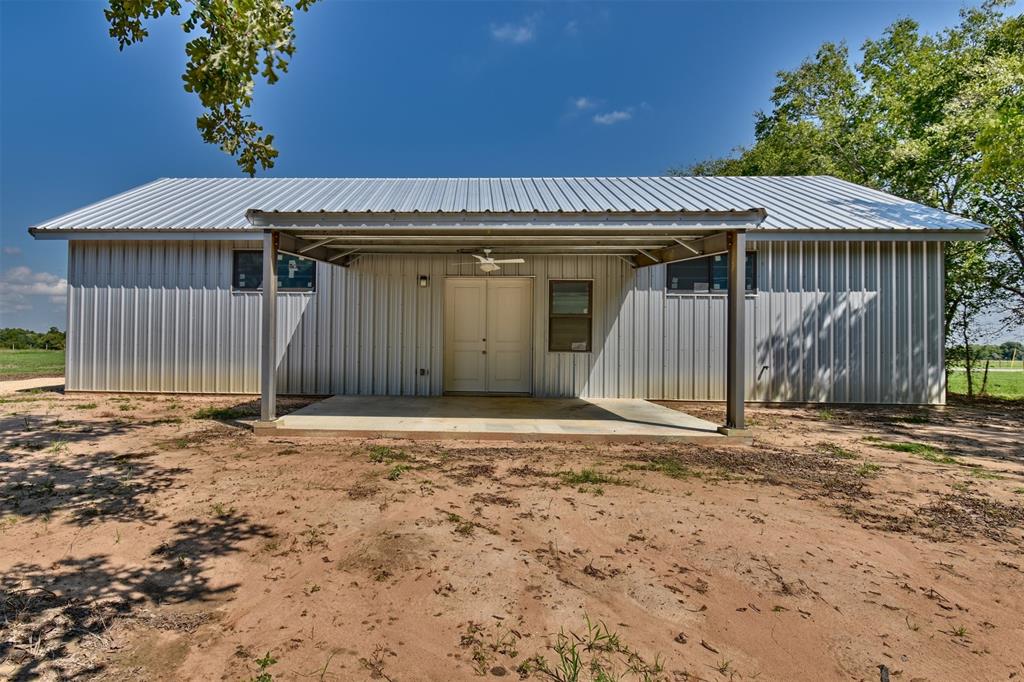 508 E Huvar Street Weimar, Texas Make this newly built 1800 sf metal building on .714 acres anything you wish. It's ready for your finishing touches. The building has 12' tall plywood walls, an 18' ceiling w/extra thick blown-in insulation, new Pella windows, a completed full bath and electric washer/dryer connections. This barndominium is move-in ready but could readily be converted to multiple rooms or made into a 2-story living space. A covered 300 sf concrete patio w/ceiling fan looks onto a shaded back yard. With easy access to Hwy 290, Weimar is 85 mi from Houston and 110 mi from San Antonio.