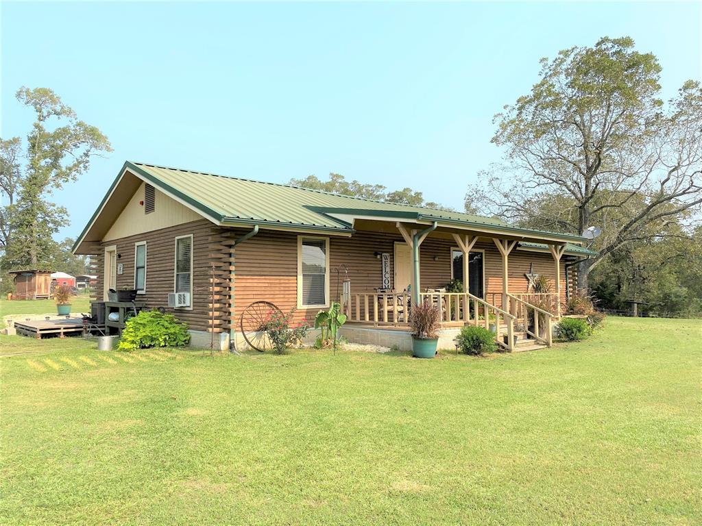 3881 Hwy 75 Buffalo, Texas This adorable log cabin style homestead is nestled right off of Highway 75 between Buffalo and Centerville. The 3.88 acres of land will give you the luxury of a large front and back yard as well as a cattle/horse pasture. With abundant wildlife and deer in the area, the cozy sitting area on the front porch is ideal for viewing and relaxing. The updated kitchen, living, and dining areas are such an open concept that nobody will miss memories being made. This 4 bedroom / 2 bath, plus a family or game room offers everything that you'll need to enjoy the comforts of country living. Don't forget to bring your chickens and equipment to have your very own mini farm. The coop and storage area are ready!