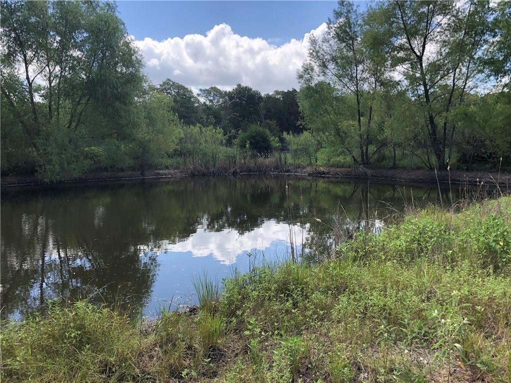1081 Old Pin Oak Road Paige, Texas 28.9 acres - just the right size for enjoying the great outdoors about 1.5 hours from Houston or an hour from Austin. Beautiful property is very private with a 60 foot wide entrance that leads back to a lovely pond, then opens out to heavily wooded acreage with some clearings and trails. Well fenced on three sides, partially fenced remaining side. Plenty of cover for wildlife. Preferred mix of hardwood and evergreens. Adjoining large tracts. This property is already platted in two tracts so easy for a family to share with 30 feet of road frontage for each tract. Seller wants to sell together. Only restriction per seller is 25 foot building set back from property lines. Adjoining 58 acres acres also for sale.