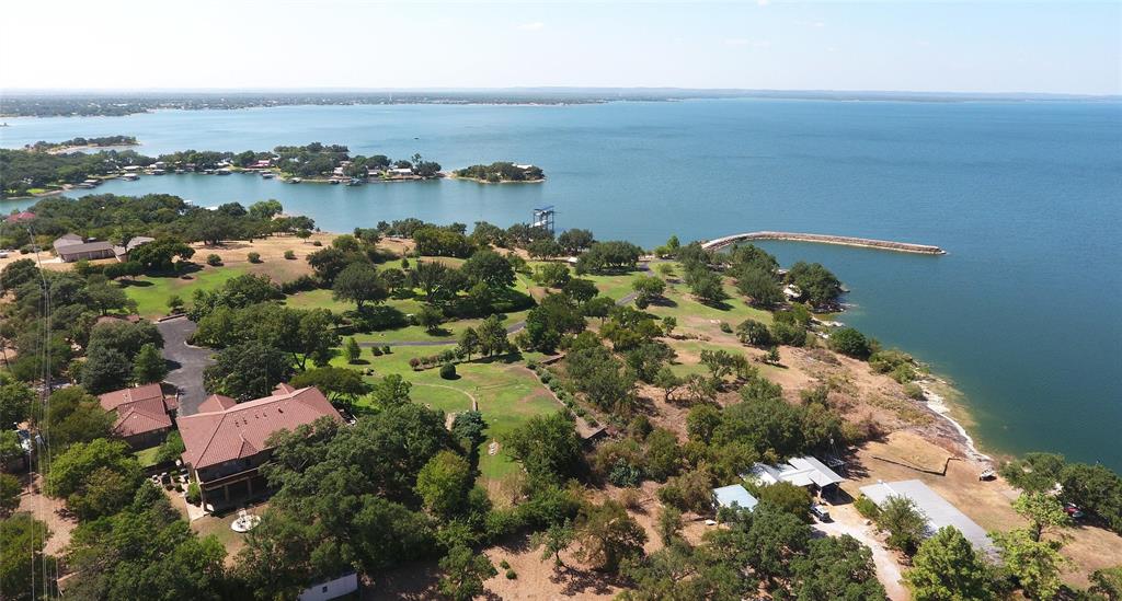 206 Forest Drive Buchanan Dam, Texas Absolutely stunning Waterfront acreage.
Approximately 1,000 feet of deep water front on the main basin of Lake Buchanan. 10 manicured acres along with 600’ long concrete jetty leading to deep water make this an incredibly unique and amazing opportunity for a family compound. Immediate income from current Airbnb rentals. With no restrictions this would also make a spectacular event/wedding venue or corporate retreat. There is a 7,000 square-foot main home along with guest homes, cabana, boathouse, launch and private beach. Excellent access off Highway 29 between Burnet, Llano and Kingsland. One hour to downtown Austin, 20 minutes to Horseshoe bay, a world-class golf and lakefront resort.