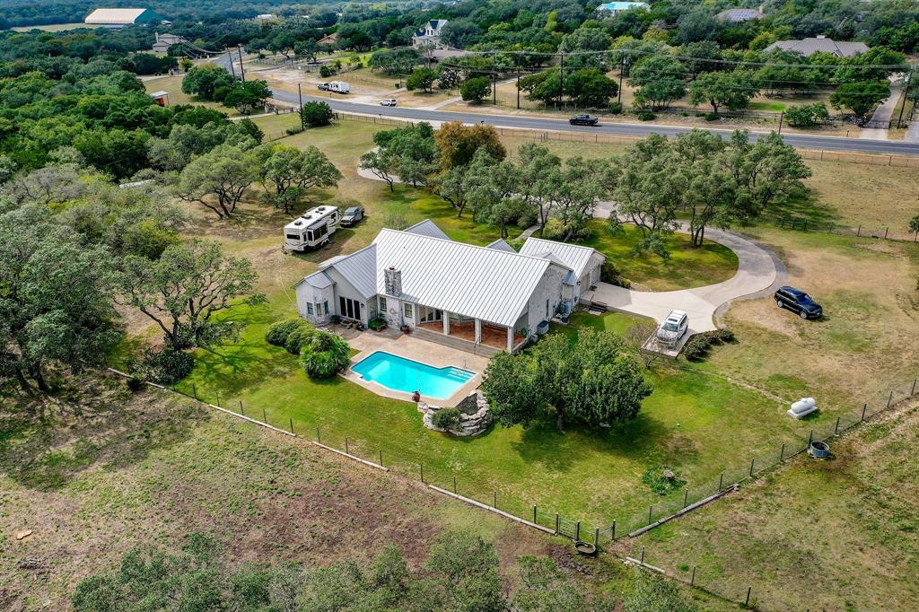 25043 Toutant Beauregard Road San Antonio, Texas True Equestrian Property. 10+Acres. One story living with a spacious floorplan! Authentic Saltillo Tile welcomes you into the open living area where ceilings are soaring and a gorgeous fireplace is the focal point of the room. Light filled chef's kitchen with custom cabinetry and granite countertops. Formal Dining and separate breakfast nook opens to the Family Room. Master retreat with wood like flooring opens to the outdoor patio and sitting area. Relax in the spa like bath with garden tub and separate shower with his/hers vanities. Master closet has abundant space. Oversized outdoor veranda overlooks the newly tiled and plastered heated pool! Beyond the pool is a fenced and cross fenced pasture. Bring your horses! They will love the 2 Stall barn and ample turnout space. 3 Stall Metal Shed with room to store your ranch equipment. Great location! Just minutes to IH-10,shopping and dining... A Little slice of heaven with city convenience.