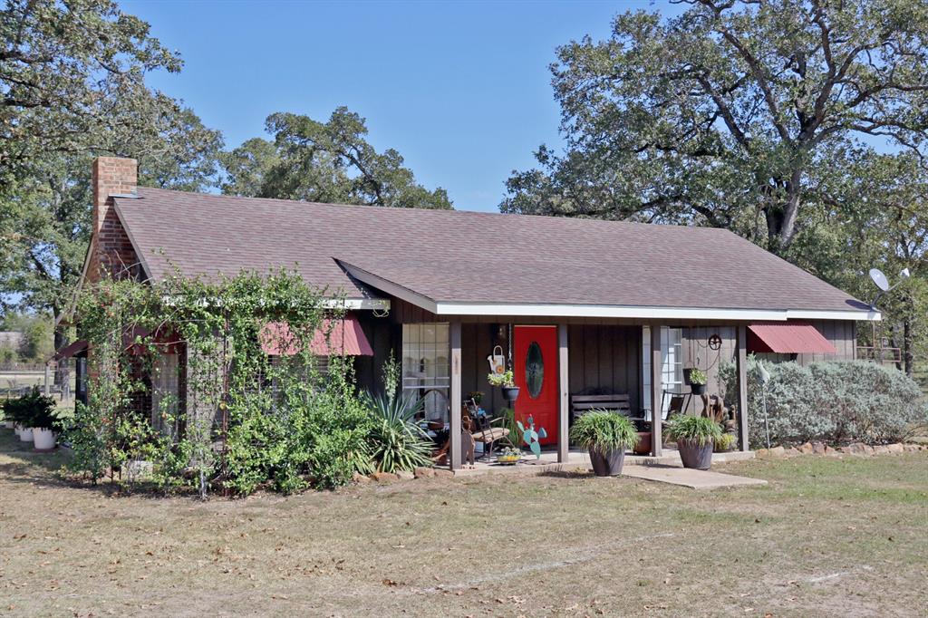18720 Fm 39 Road Bedias, Texas When you think "cottage in the country" this is it! This adorable 2/1.5 with an office is situated in amongst the hardwoods with a beautifully landscaped yard. The cozy farmhouse styling makes you immediately feel right at home. Through the kitchen window, you can see the well manicured back yard and pond in the distance. The property also features a number of outbuildings that are used for a variety of uses including: a carport, dry storage/outdoor kitchen, office space and even an additional bedroom. The fencing and FFA type pens are the perfect final touch to make this a ready home place. Bring the kids, pets and fishing poles!