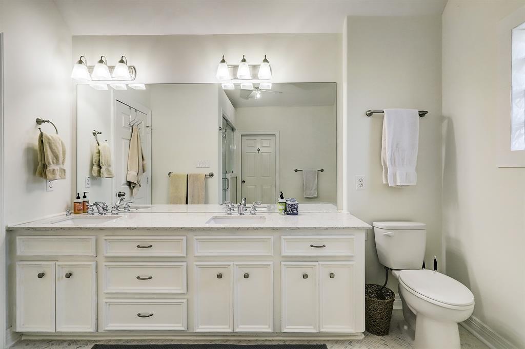 The stunning primary bath with a dual bowl vanity was updated in 2019 including marble floors, new lighting and new tile.