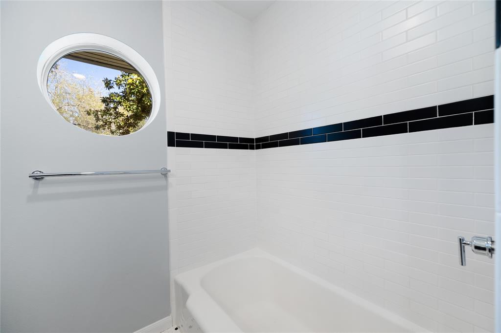 A combo shower/tub with classic subway tile.