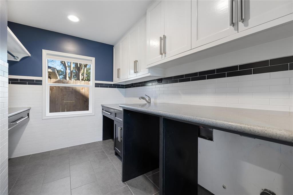 The last of the interior spaces, this laundry room is to die for ... with side-by-side washer and dryer connections, ridiculous counter/folding and cabinet space, a sink and a hanging rod.
