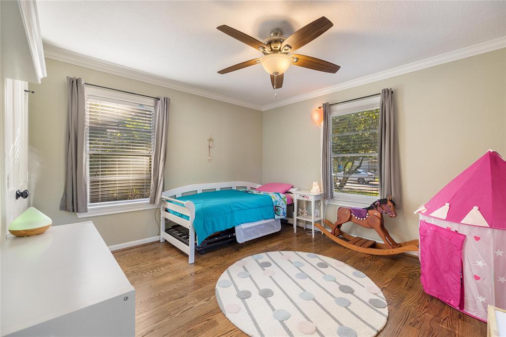 Another generous sized bedroom with crown molding and hardwood floors.