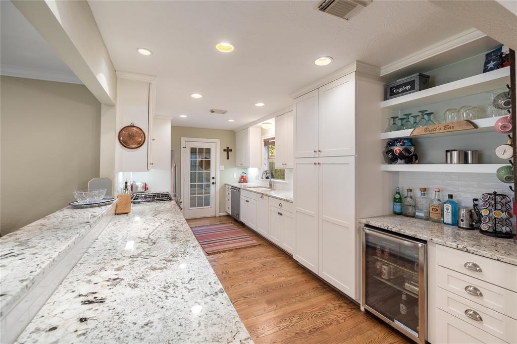 The remodeled kitchen offers tons of cabinet and counter space. The dry bar includes a beverage fridge and plenty of storage as well.