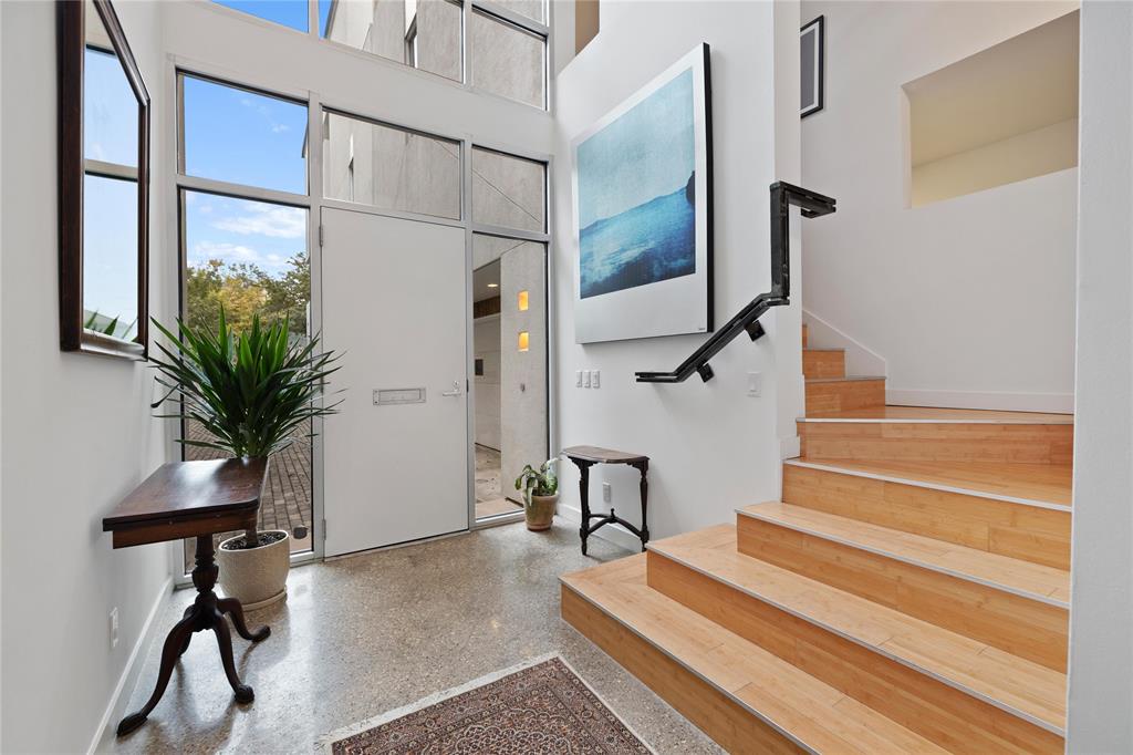 The entrance way is bright and welcoming, with wrap around staircase to living area.