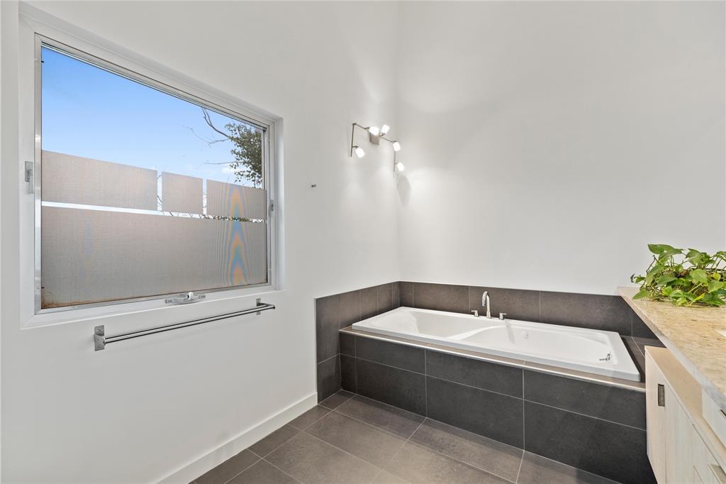 Sleek Primary ensuite with bathtub and separate shower.