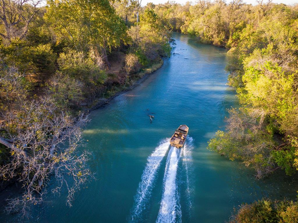 8869 FM 466 Gonzales, Texas Premier Guadalupe River Front property with excellent water access located on FM 466 in South Western Gonzales County. This ranch has approx. 2,000 feet of pristine Guadalupe River frontage that is accessible in several locations. The ranch has paved road frontage, numerous old barns and sheds, an old camp house, water well with electric pump and 3 electric meters already in place. New fencing along the hwy and the western boundaries were just completed. The large hill where the old homestead is located you will find numerous mature Live Oak Trees which provide an excellent shaded overlook onto the 3,400 ft. river bottom pastures.