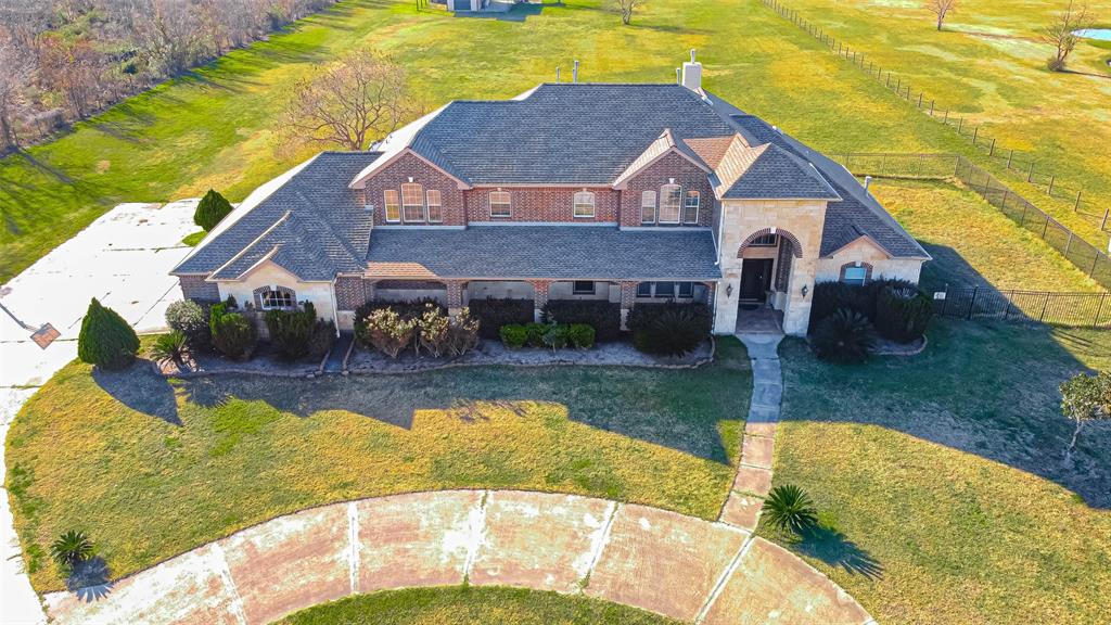 18701 Bauer Road Hockley, Texas This Custom Estate Family Home on 5.2 acres of unrestricted land will steal your heart. Some special features include a floor to ceiling stone fireplace, second gas fireplace, wet bar, curved staircase, secret room upstairs, separate guest quarters, no carpet, 3 car garage and unfinished Barndominium. Numerous updates have been made including a new roof installed in 2018. Ask your Realtor for the full updates list. A large covered patio and fenced in side yard work great for keeping close watch on young children or small pets. The two-story Barn is fully equipped with electricity and plumbing and it's a blank canvas ready to be transformed into the Man Cave of your dreams! Watching a sunset from the second story balcony is remarkable. Just outside the barn is a fire-pit and outdoor cooking area with a grill and sink. This special property has everything you need for Country living and plenty of space for your dream pool. Easy access to 290. NO FLOODING per seller. Priced to sell!