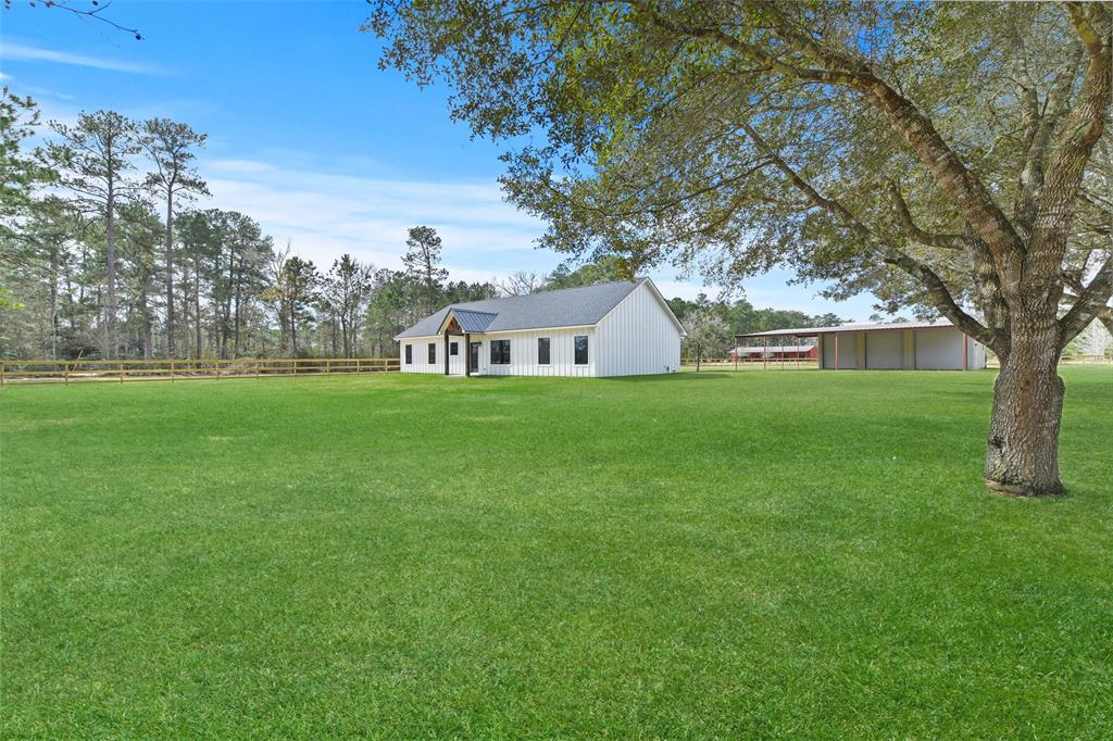 525 County Road 2224 Cleveland, Texas This new construction Farm House on The Prairie is a show stopper! Nestled on 1.5 fully fenced acres on a quiet County Road in Tarkington ISD. Sleek and exciting finishes include black granite countertops, wood-like tile, clean line moldings, soft close drawers/cabinets, energy efficient windows and frameless shower in master bath. The master bath also includes double sinks, his and her walk in closets, soaker tub and separate toilet room. Large bedrooms with custom oversized closets joined by Jack and Jill bath with separate toilet/shower room. This home boasts an open floor plan, high ceilings, a generous outdoor entertaining space. A walk-in pantry with custom shelving large enough for food and kitchen gadgets. Spacious laundry/utility room w/ cabinets, hanging space, room for a safe, freezer, or hall tree. Also included on the property is a 40x40 metal shop with 3 bays and awnings all around, full bath and office. Recently fenced, it’s beautiful! Schedule your showing today!