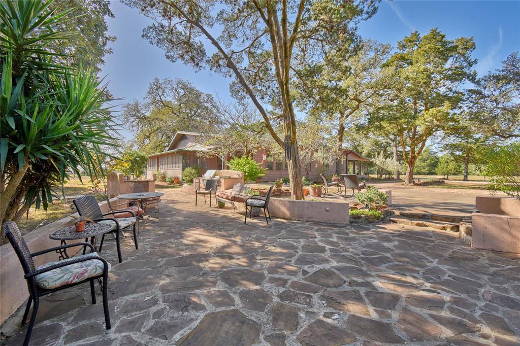 3353 Fm 957 Hallettsville, Texas Tranquil secluded approx 70 acre farm located 3 miles North of Hallettsville, TX on FM 957. Main house features 3 bedrooms, 2 baths with office. Newly remodeled kitchen and living room in open concept featuring cast-iron wood stove with raised rock hearth. Separate utility room, screened porches on either side of house with a wide open covered porch off the master accessed through French Doors. Detached 2 car garage with circular gravel driveway. Guest house with one bedroom one bath. Sandstone/stucco patio with firepit, built in gas grill and sink connects the two houses under a canopy of oaks and cedar trees. A 30 x 40 metal workshop with electric and water and overhead bay door for storing equipment. Pole and slab barn. Seasonal creek and stocked pond. Wildlife tax exemption and 5 grazing/hay pastures, water well which serves both houses and second well for water to cattle troughs. Rolling Terrain 100 miles from Houston, Austin and San Antonio. Owner related to Broker.