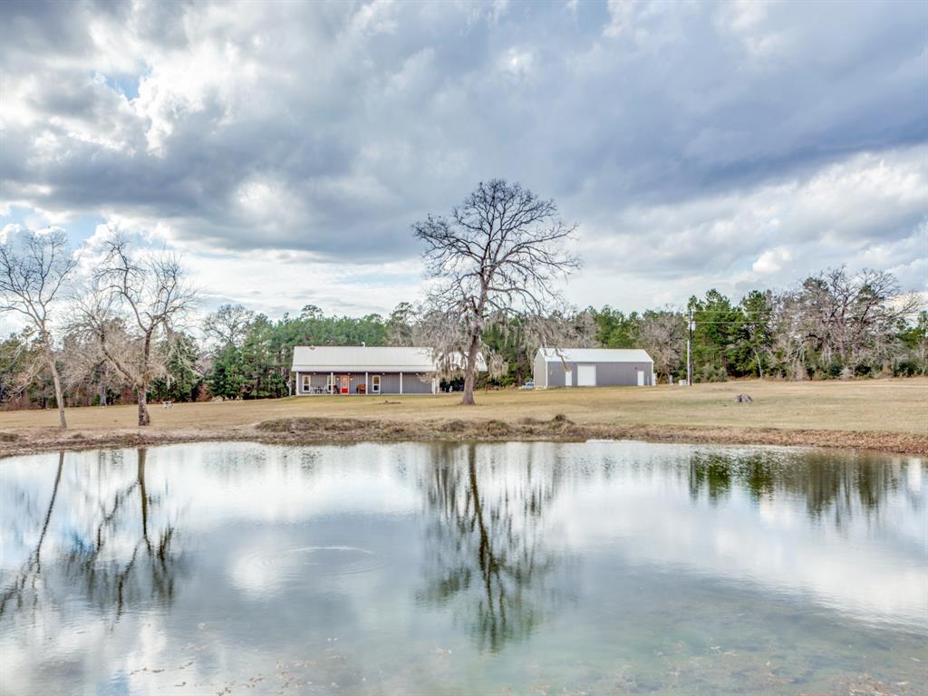 10554 County Road 208 Navasota, Texas 18.52 acres with everything you need to enjoy country living close to town! Unique property delivers a mix of wooded and cleared space, rolling pastures, a stocked pond, and stunning views everywhere you look. 17.52-ac is AG exempt -- ready for livestock, wildlife watching, hunting, or other country pursuits.
Main 4-bed, 2-bath home is 1722 sqft with open kitchen/living, huge granite island with bar seating, ensuite primary, plus addtl. 600+sqft of finished space ideal for man cave/she-shed, extended living, new primary, etc. Full porches front and back, back opens to a gorgeous heated pool with full deck, stonework accents, and waterfall. Attached carport offers plenty of parking. Barndo bldg. adds 2700 sqft of space: 900-sqft apt. with kitchen/laundry; 900-sqft open storage; 900-sqft 2nd story office.
PLUS! 2 RV hookups, Generac generator, 1000 gal. buried propane tank, 1000 gal. fuel tank, storage shed, and more! Located in Anderson-Shiro ISD, close to new Aggie Expressway.