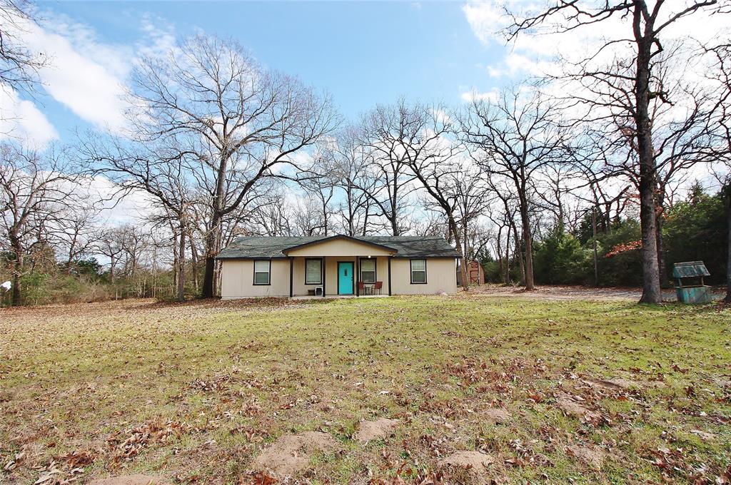 2141 County Road 303 Buffalo, Texas Simple country living! Great wood siding home on slab tucked in the trees on a 1.39 acre wooded lot between Buffalo and Centerville. This 4 bed 2 bath split plan home features high ceilings in the living room and primary bedroom with wood accent beams that make the space feel big and open. Tile floors and tile countertops make for easy care and cleaning throughout the home. The all electric kitchen includes all appliances including the refrigerator. Bedrooms are all ample size and the primary bath features a tile step down shower with built in seat. You'll enjoy your morning coffee on the covered front porch and the kids or grandkids will enjoy the spacious wooded back yard. Other improvements include a slag driveway and convenient storage building. Home needs some fresh paint and a few minor repairs to bring it back to life but is otherwise ready to enjoy. Come check it out!