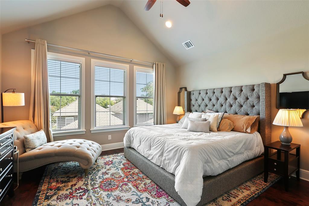 The spacious primary suite features a vaulted ceiling, walk-in closet and lots of natural light