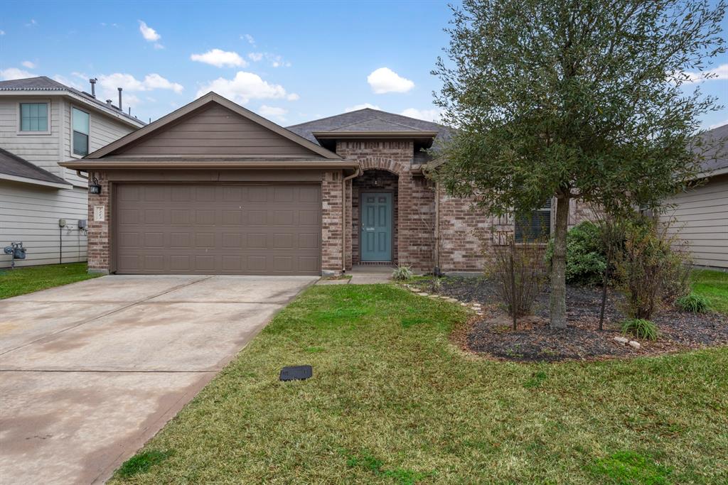 7263 Basque Country Drive Magnolia, Texas MOVE-IN READY 4-2-2 one story with SS Refrigerator and Full-size Washer & Dryer! This charming home features a large open concept kitchen with ample cabinet and counter space plus an oversized island, stainless steel appliances, granite countertops, vaulted living room ceilings, no carpet, faux wood tile in all 4 bedrooms and living area, 2" blinds throughout, HVAC with AIR SCRUBBER and a low maintenance backyard! Zoned to great schools in Magnolia ISD!