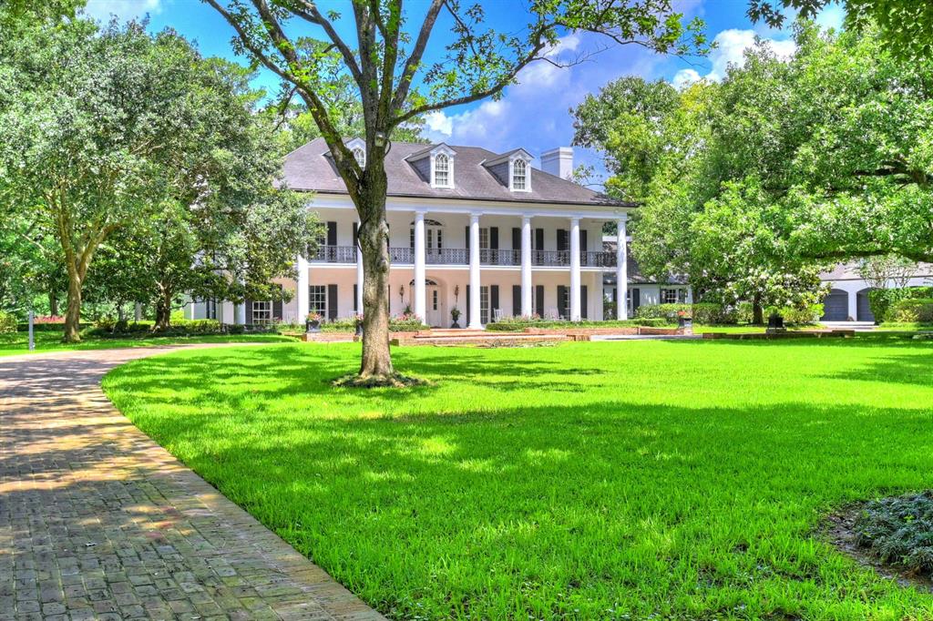 A magnificent colonial estate in the heart of Memorial one of Houston’s most prestigious st.The 4 +acre secluded estate is 2 miles from The Galleria w/a private lake, tennis court & pool lot can be subdivided. Grounds have infrared beams surrounding home & security cameras. Soaring ceiling w/marble floors & self suspending staircase invites you into a foyer that floats into an exquisite formal dining room w/new Gracie wallpaper (morning room as well) All 3 floors have refinished walnut floors.Office/den is all mahogany panel w/ floor windows throughout the house that have shutters that close in case of a storm. Security and cooling system for the house is computer monitor & control. Home features 3 levels, 5 bedrooms, 4 full baths, 3 half baths, quest house w/large living area bedroom full kitchen & two bathrooms. Quarters apartment w/full kitchen, 7 cars garage a/c, 4 year old (200 Kilowatts)generator for entire house, 2 large storage buildings, a water well for the lawn