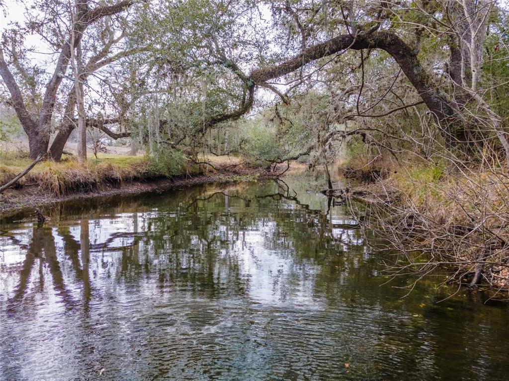 2224 Garrett Road Yoakum, Texas Remarkable 64.75 acres out of a total of 129.5 acres in DeWitt County just outside of Yoakum, Texas. Outdoor and hunting enthusiasts dream with bountiful wildlife: deer, ducks, dove, turkey, and hog. Make this your hunting camp, cattle ranch, recreational property, or build your dream home. Live oaks are abundant on the property and the rich hearty soil provides plentiful grasses for livestock and wildlife. This property has two small stock tanks, two large stock tanks/ponds and a nice creek running through it. Two barns, both with electrical and one with plumbing, for your workshop and equipment/ recreational vehicle storage. A quick drive to US-77 which makes Victoria, Corpus Christi, Houston, San Antonio, and Austin all very accessible. Don't miss out on this one, let's see it today!