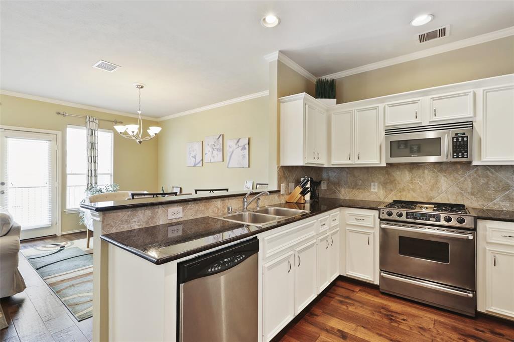 You'll love the counter space and cabinet space this kitchen has to offer. You'll also love the stainless steel appliances and four burner, gas cook-top.