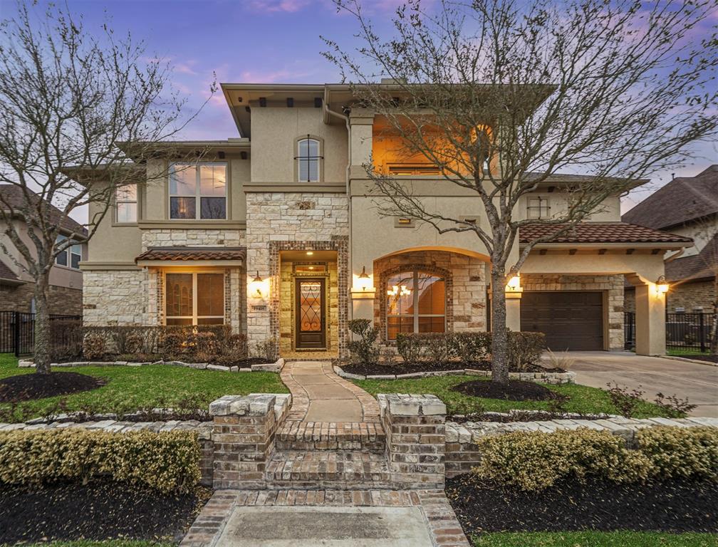 19418 Water Bridge Drive Cypress, Texas Spectacular waterfront home featuring a backyard oasis complete with a pool & spa, outdoor kitchen, outdoor fireplace, two covered seating areas & lake views! Home offers over 4,400 sq ft of luxury living that includes a grand entry with sweeping staircase, two story family room, gourmet kitchen, private study, gameroom, media room & beautiful finishes throughout. Two covered 2nd story balconies - one has great backyard/lake views. The kitchen is equipped with double ovens, 5 burner cooktop, large island with designer pendant lighting above, upper glassfront display cabinetry & a butlers pantry with wine fridge that leads to the dining room. The owners suite has a sitting room/office area & luxurious bath. Step outside under the covered patio that looks towards the sleek pool & spa. A large pergola covers the full outdoor kitchen & beautiful stone fireplace. Mosquito control system. Paved walking trail behind home extends for miles. Zoned to top schools. Don't miss this one!
