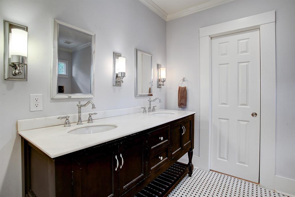 This beautiful primary bath has a double vanity and classic, timeless finishes!  The door leads to the walk-in closet.