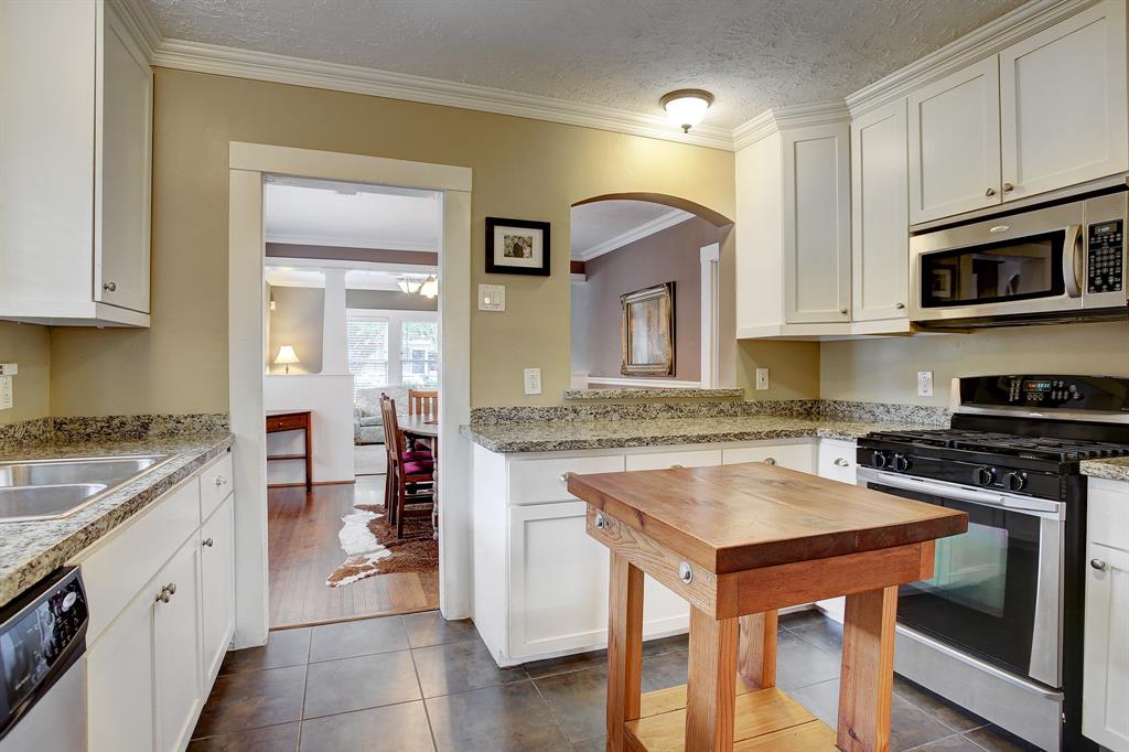 The updated kitchen with stainless appliances uses every inch of space well, including cabinets to the ceiling. (The island is excluded from the sale.)