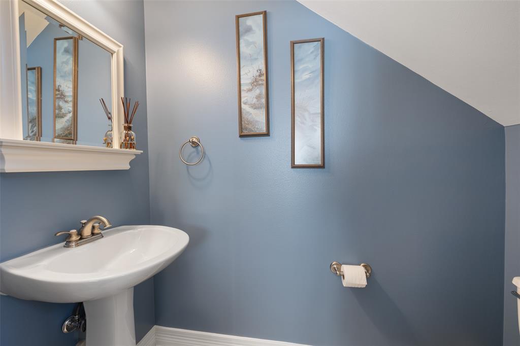 The perfectly appointed first floor half bath is discreetly located under the stairs off the living/dining area.
