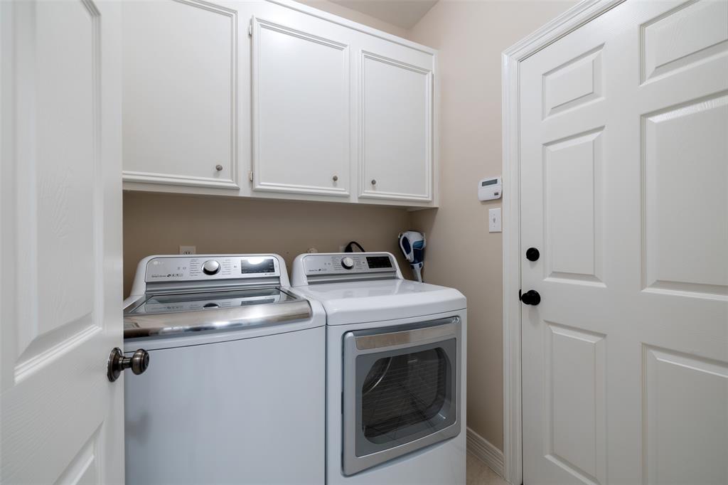 The laundry area is just inside the door to the garage and includes wonderful additional cabinet/storage space. This room has its own door so laundry can be done any time of day.
