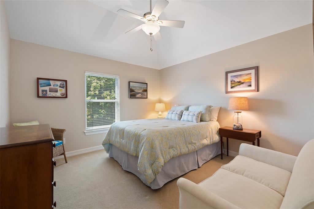 The first of two bedrooms on the second floor sits just beyond the loft space and overlooks the back yard.  Both secondary bedrooms have great space for furniture as well as walk-in closets.  This bedroom's closet has access to the attic storage space over the garage.