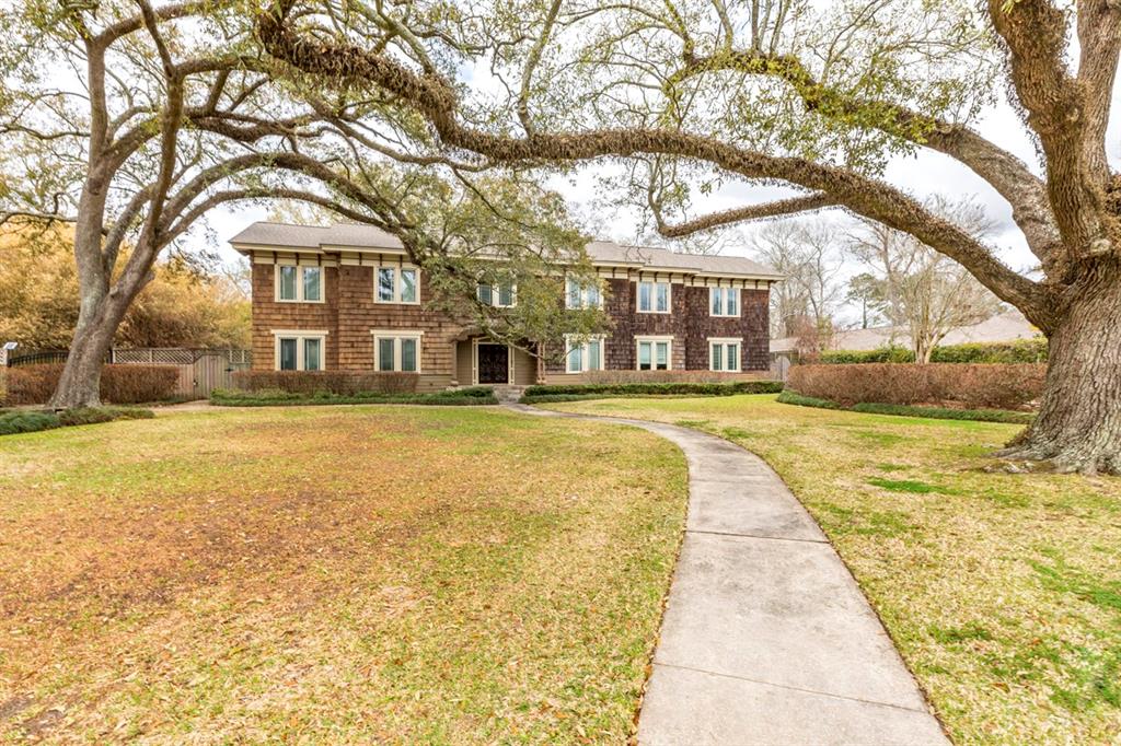 170 N Caldwood Drive Beaumont, Texas Cedar shakes, beautiful, mature trees, and lush landscaping welcome guests to this stunning Caldwood home. Walking through the arched doorways of this home, you'll find wood flooring, built-in bookcases and storage, and rooms full of light shining through the many windows. The kitchen is a dream with numerous floating shelves, a gorgeous backsplash, a Wolf double oven range, two sinks, two dishwashers, and granite countertops. You'll have plenty of parking space with gated parking to fit 7 cars. Gather your guests around the outdoor fireplace to roast marshmallows on a cold evening. On a warm day, the covered patio or mature trees offer plenty of shade or take a dip in the in-ground pool while soaking up the sun. This home is a gem that you don't want to miss out on!