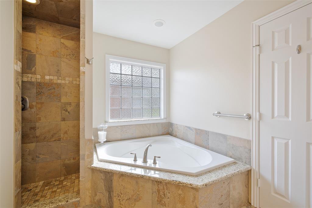 The primary bath also features a separate tub and shower.