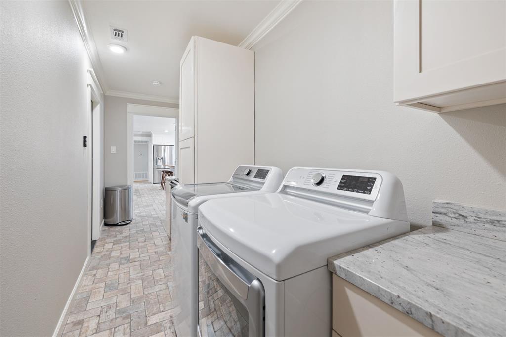 Spacious Utility Room includes washer/dryer connections, ample storage, and wine fridge