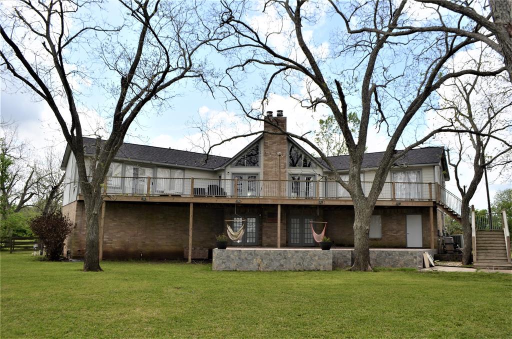1810 Pecan Lake Richmond, Texas Beautiful two acres with 21 pecan trees on Burton Creek, stalked with fish, great for Kayaking and canoeing. Incredible view from 70x15 foot upper deck. Enjoy the 21x17 foot patio downstairs, fantastic for summer parties. Great game room with wet bar, fireplace and French doors leading to lower patio. Open floorplan, den has ceilings and pretty fireplace. Extra large three car attached garage plus 36x26 foot workshop. This property is a nature lovers dream. Roof is two years old being sold as is!